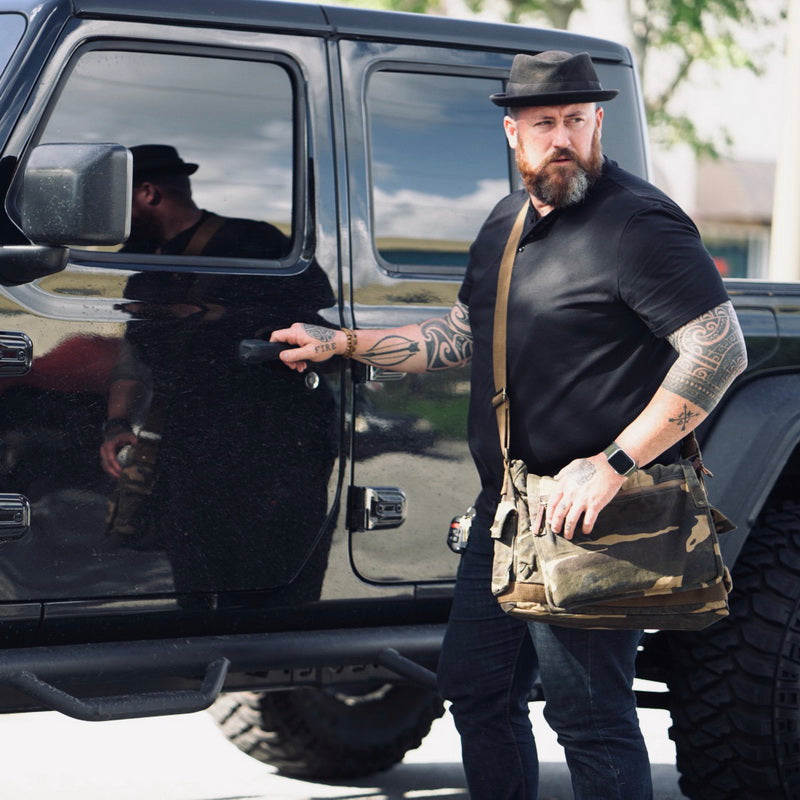 Man wearing vintage  canvas messenger bag outdoors
