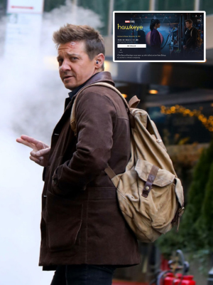 A man wearing a brown coat and a beige canvas backpack stands outdoors with his hand raised, with a small inset screen showing a Marvel-themed image in the upper right corner.